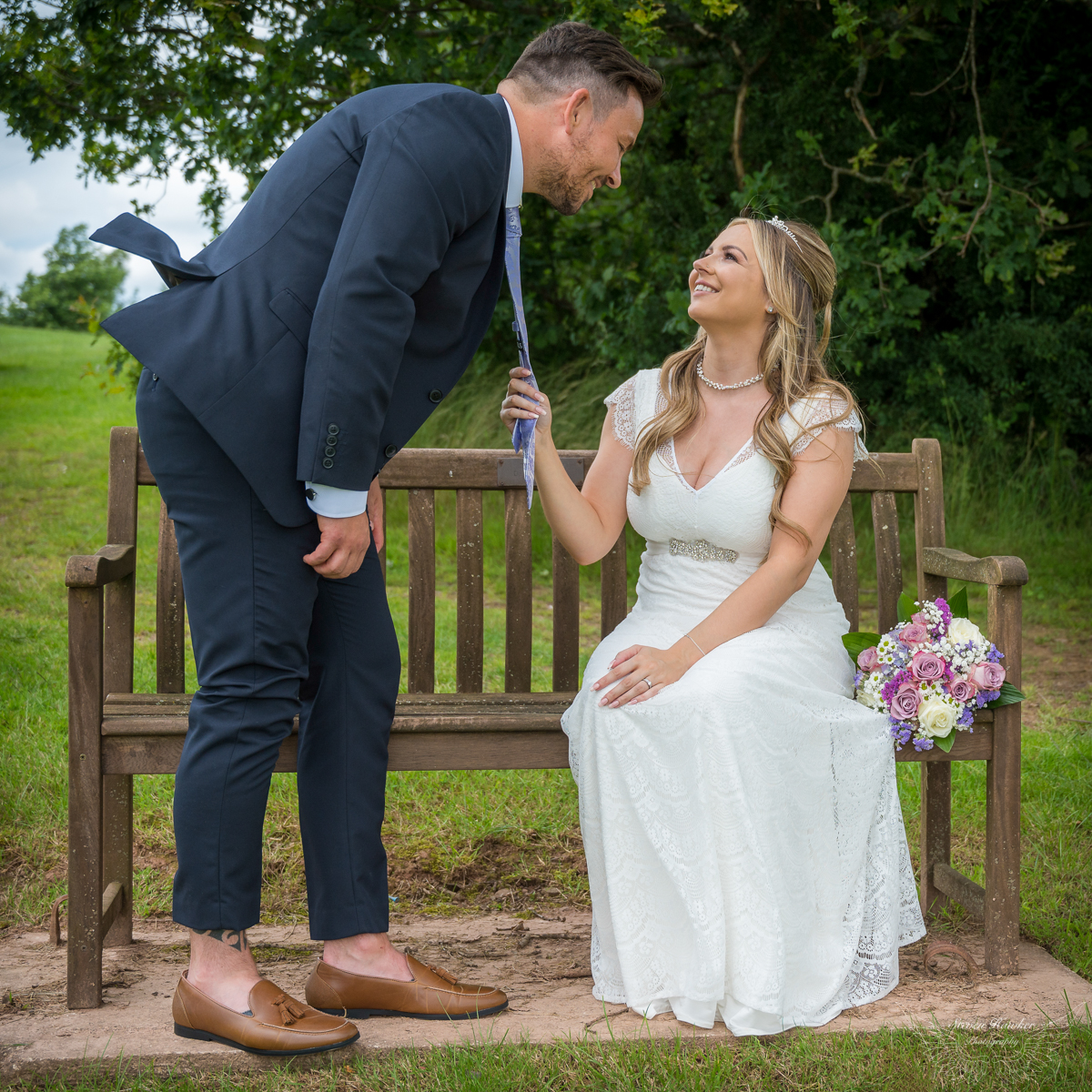 Bride pulls groom in for a kiss at Tredegar Park Golf Club